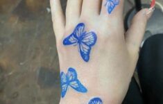 Blue Butterfly Tattoo On Hand In 2020 Butterfly Hand Tattoo