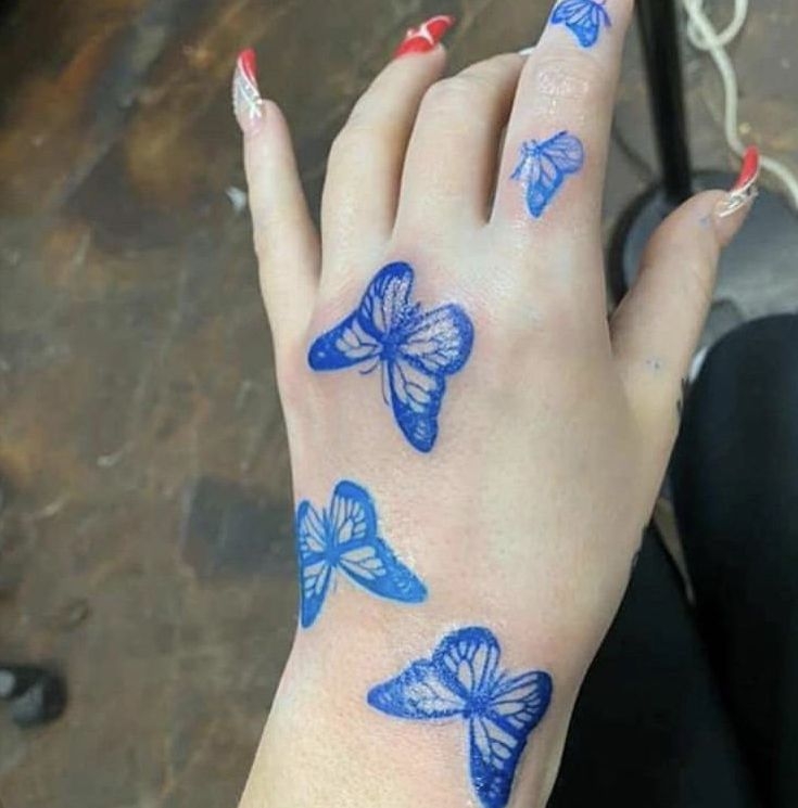 Blue Butterfly Tattoo On Hand In 2020 Butterfly Hand Tattoo 